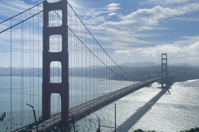 A suspension bridge with two towers, spanning a body of water. 1