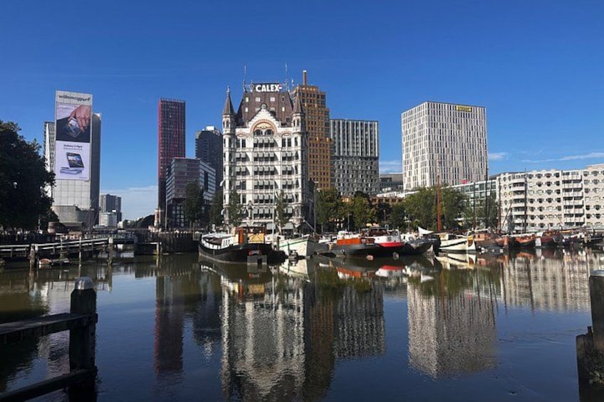 A cityscape with a prominent building labeled 'CALEX' reflecting in the water, surrounded by modern high-rises and a calm river. 5