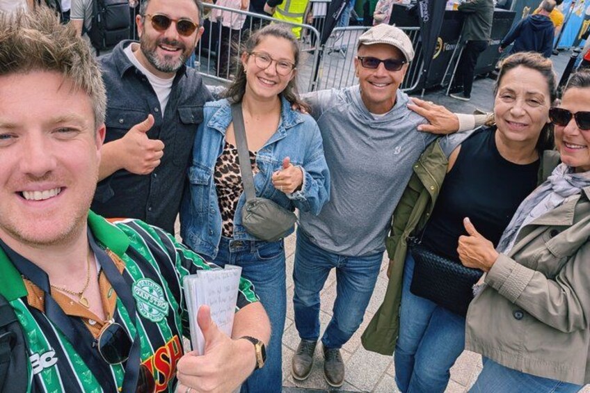 A group of people posing for a photo at an outdoor event. 4