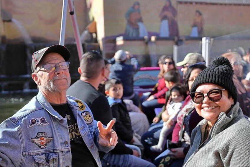 A crowd of people at an outdoor event, some wearing denim jackets with patches. 4