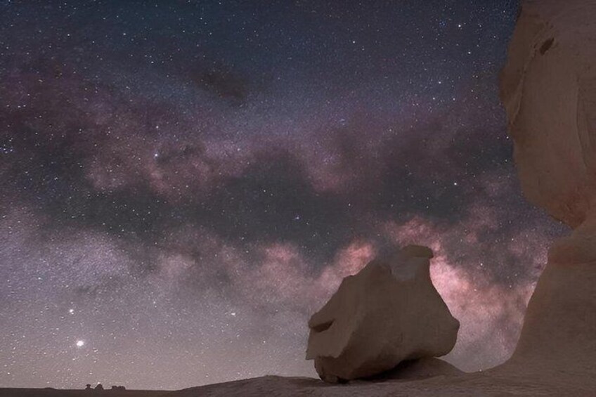 A rock formation under a starry night sky. 2