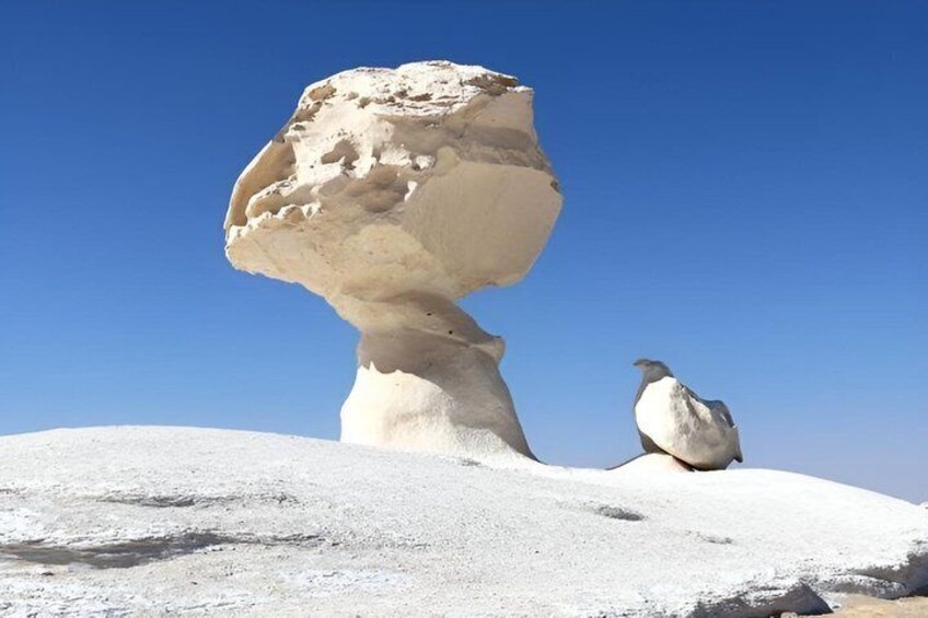 A rock formation with a bird perched on it. 3