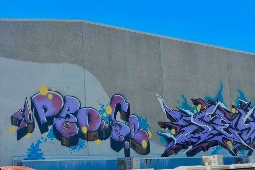 A building with graffiti art, including stylized text and abstract designs. 5