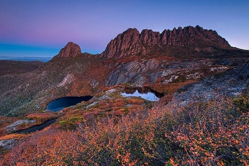 A mountainous landscape with a lake and autumn foliage. 3