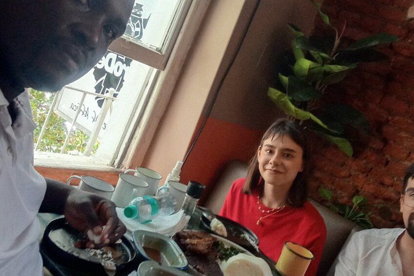 A person serving food at a table with a window in the background. 3