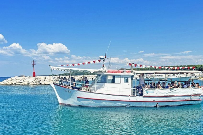 A boat named 'GALEB' with passengers, a lighthouse, and a rocky shore in the background. 5