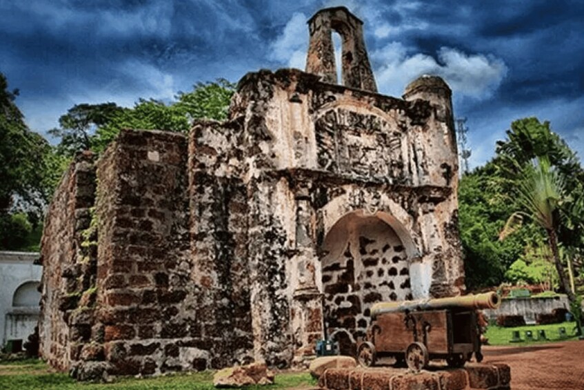 An ancient stone structure with a large cannon in front. 3