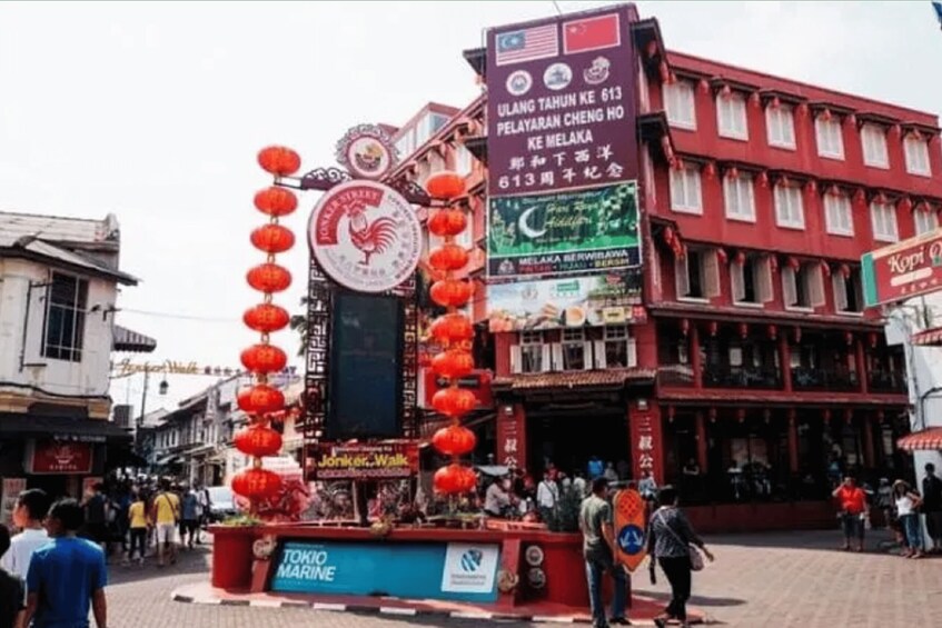 A street with red lanterns, a sign for Tokico Marine, and a building with multiple windows. 2