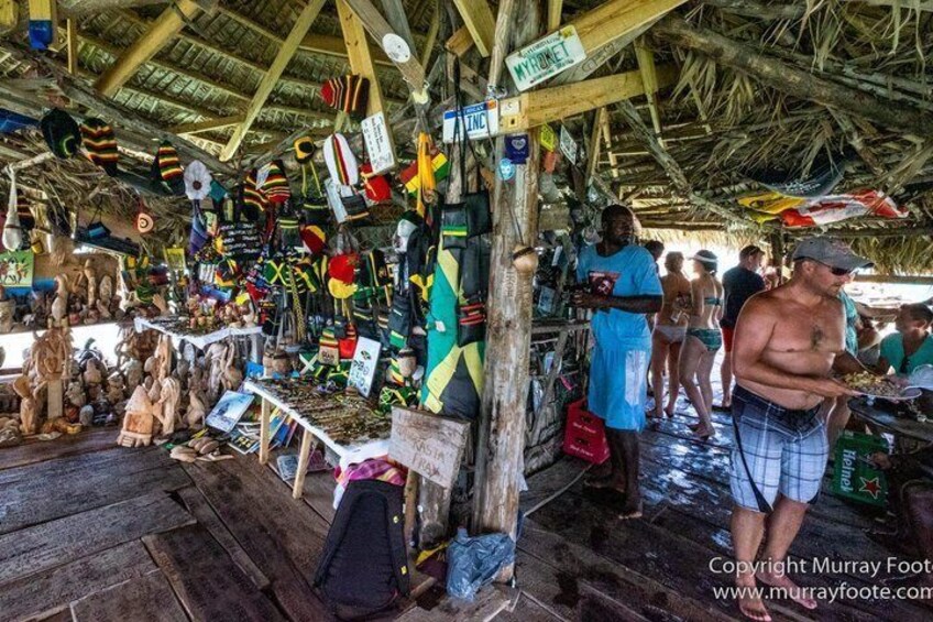A market stall with various items for sale, including hats and souvenirs. 2
