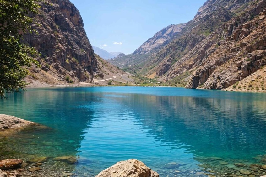 A clear blue lake surrounded by rocky mountains. 2