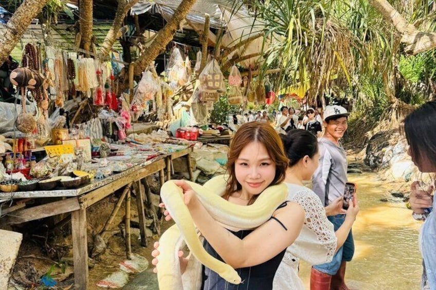 A market with stalls selling various goods, surrounded by trees. 4