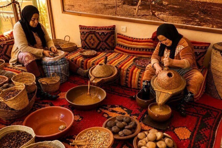 Two women sitting on a patterned rug, working with pottery and various containers. 4