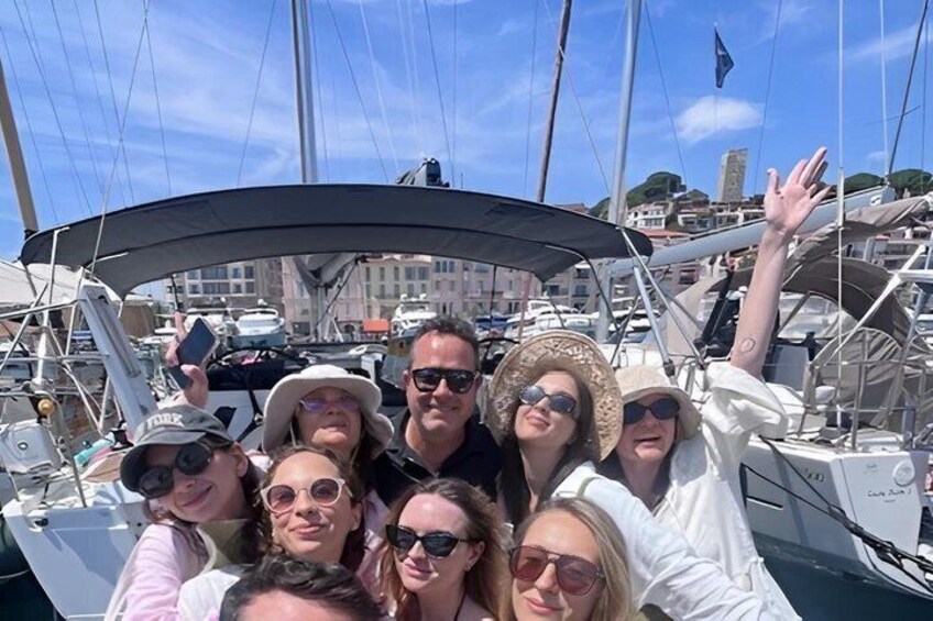 A group of people on a sailboat with a marina in the background. 4