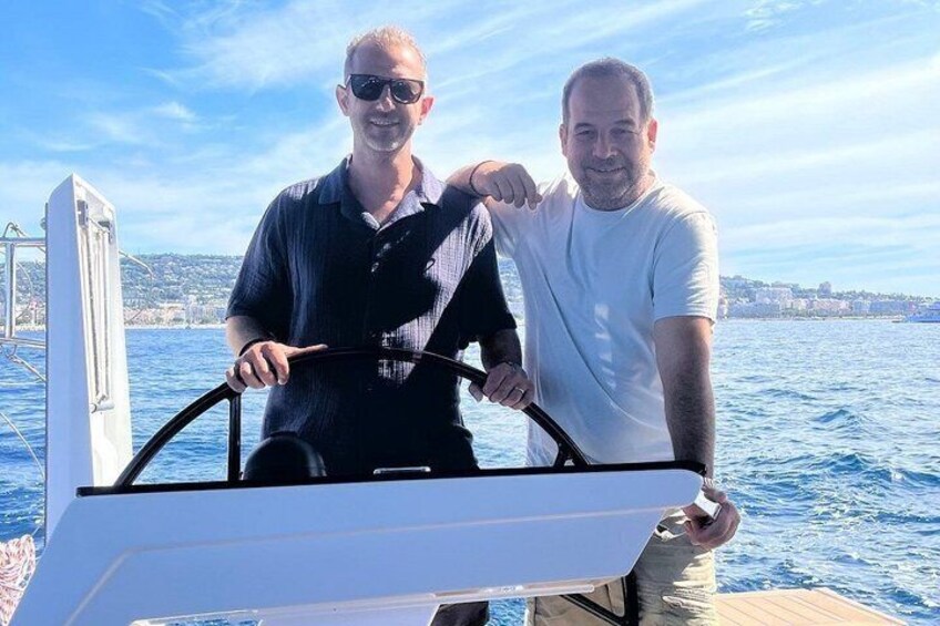 Two people on a boat with a cityscape in the background. 5