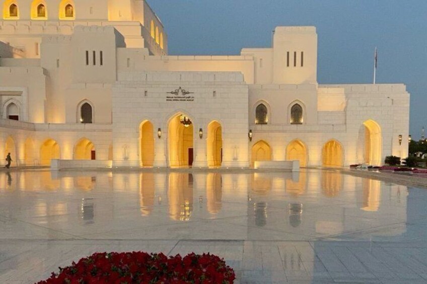 A large white building with multiple arches and a reflective floor. 3