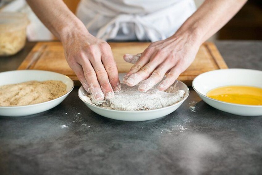 Manos mezclando ingredientes en tazones sobre una encimera de cocina. 5