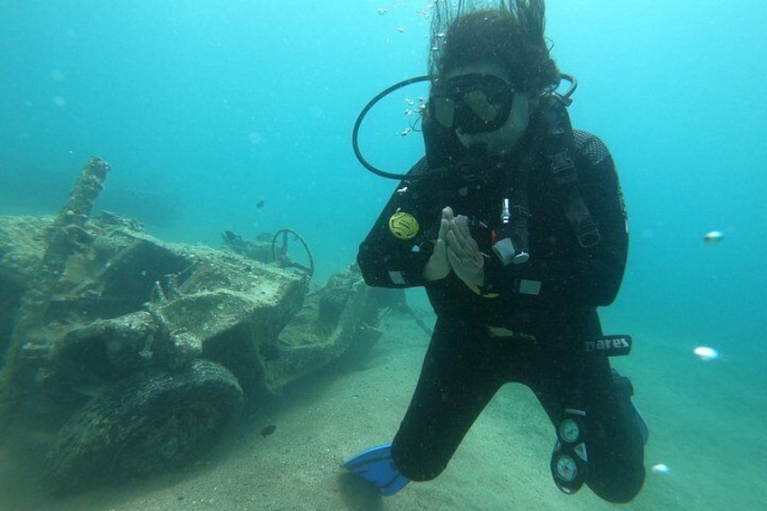 A diver underwater near a shipwreck. 1