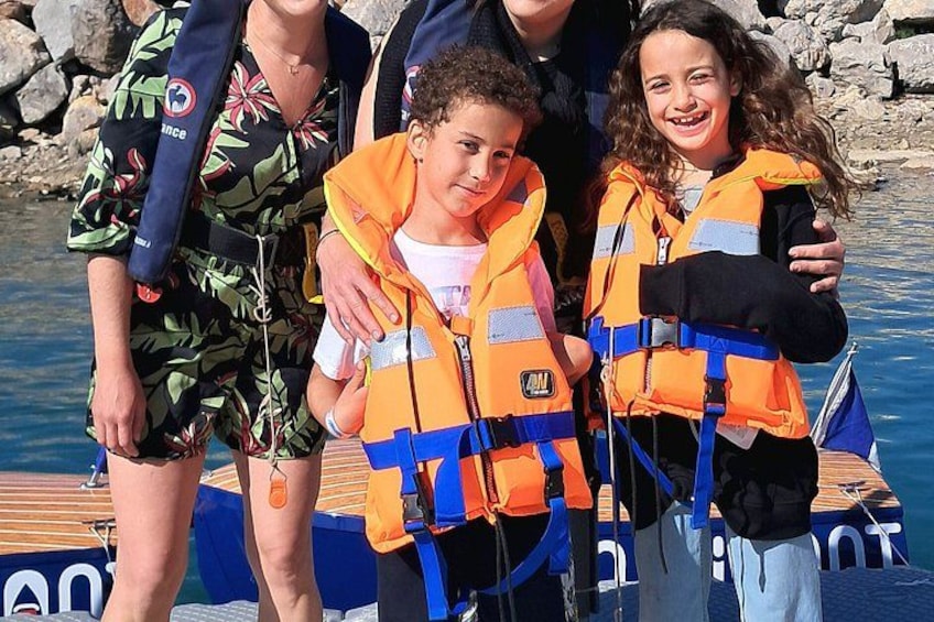People wearing life jackets on a boat. 5