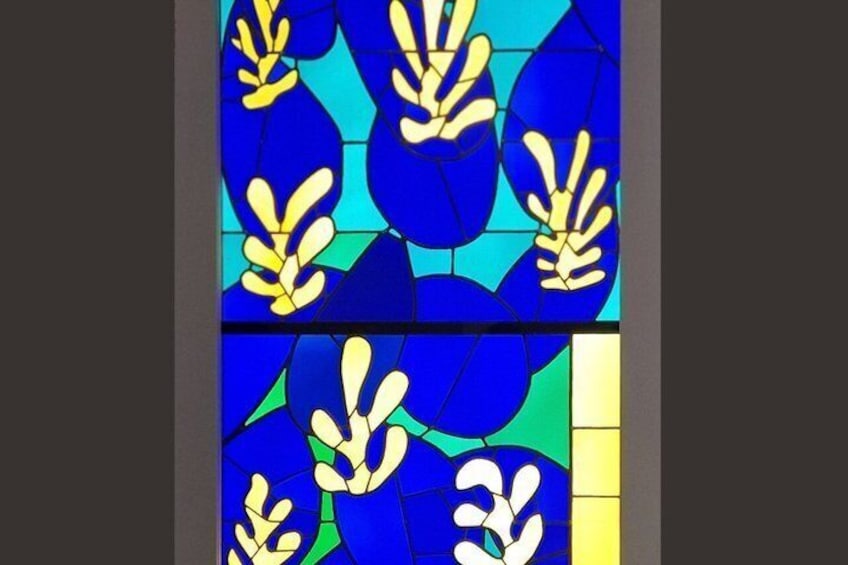 Ein Buntglasfenster mit blauen und gelben floralen Mustern. 4