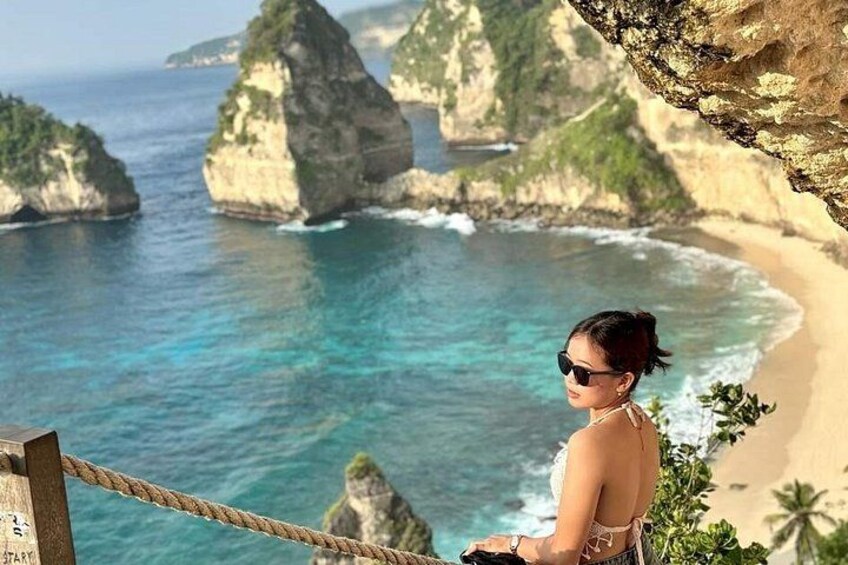 A person overlooking a coastal landscape with cliffs and a beach. 2