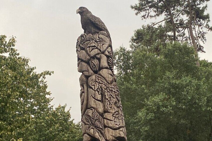 A stone monument with a bird figure and floral carvings. 2
