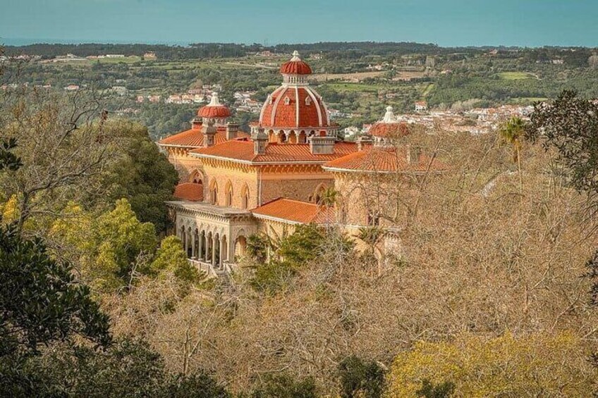 A historic building with domed architecture, surrounded by a hilly landscape. 5