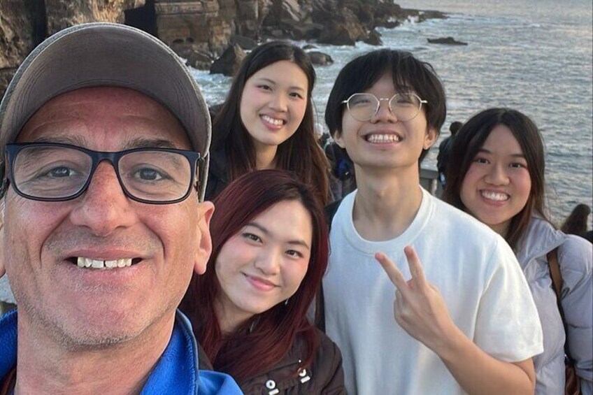A group of people near a rocky coastline. 3
