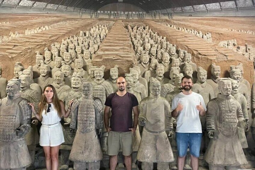 A large number of terracotta warrior statues arranged in rows. 3