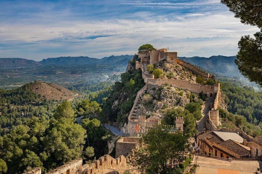 A historic fortification on a hill with a view of the surrounding landscape. 4