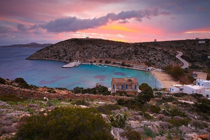A coastal landscape with a rocky hill, a small harbor with boats, and white buildings. 3