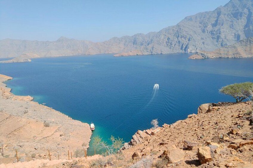 A large body of water surrounded by rocky terrain and mountains. 2