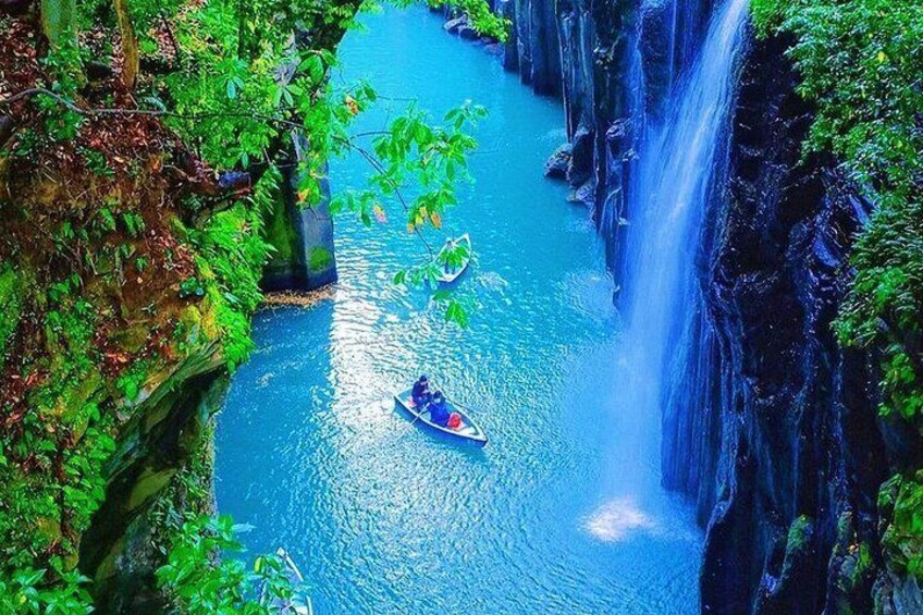 A river with a waterfall, surrounded by lush greenery. 5
