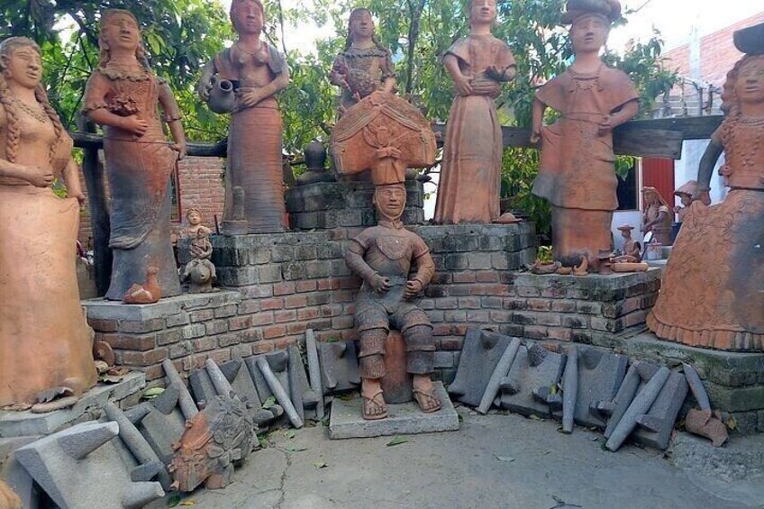 Terracotta statues of various figures in traditional attire, arranged on brick platforms. 2