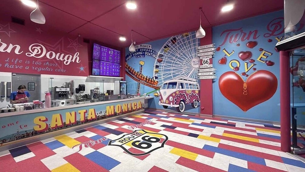 A colorful interior with a Santa Monica sign, Route 66, and a Ferris wheel. 3
