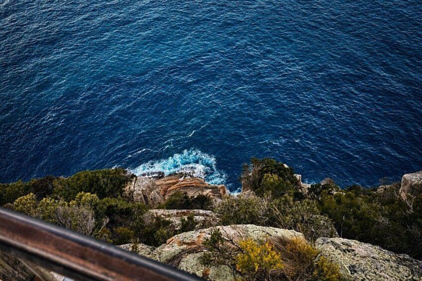 A coastal landscape with rocky terrain and the ocean. 4
