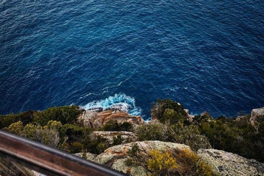 A coastal landscape with rocky cliffs and the ocean. 2