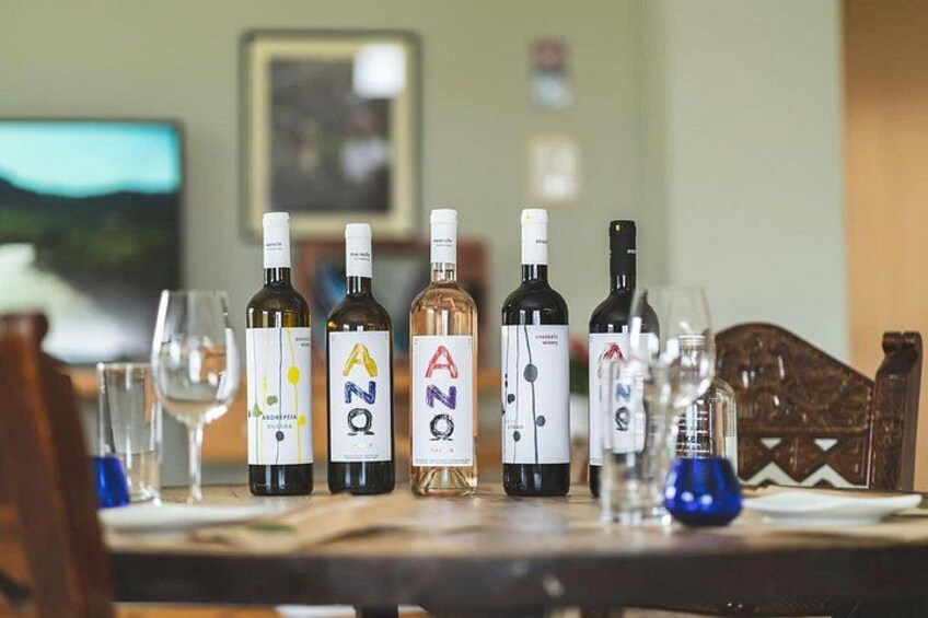 A table with wine bottles and glasses. 2