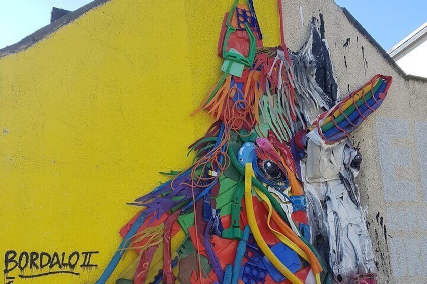 A colorful mural of a unicorn on a yellow wall. 3