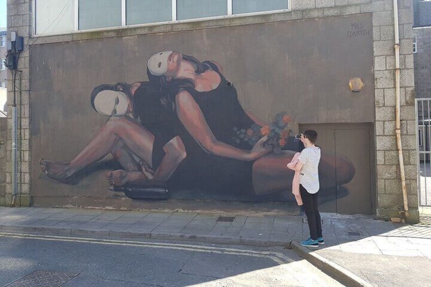 A mural of a woman with a headscarf on a wall. 5
