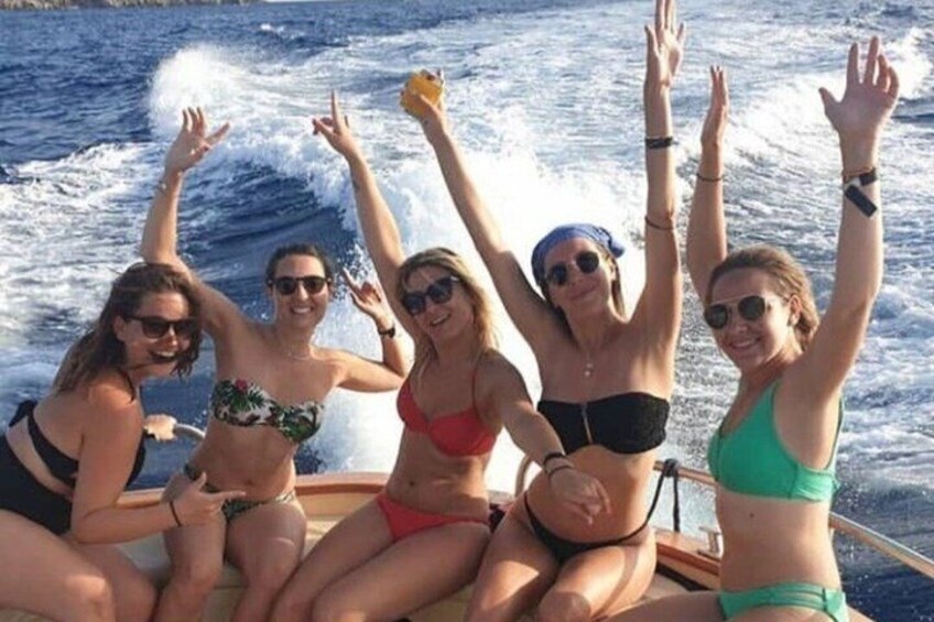 A group of people on a boat with the ocean in the background. 1