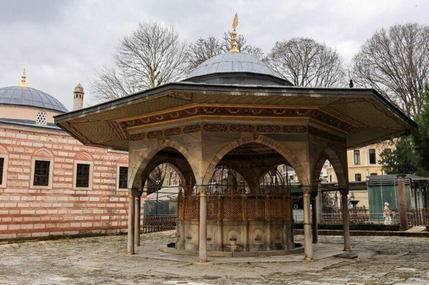 A historical building with a dome and a pavilion with arches. 2