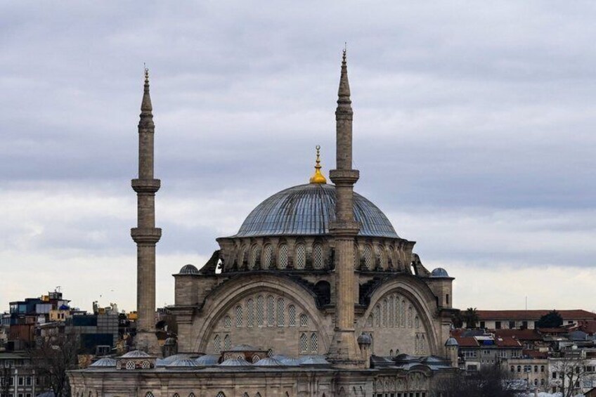 A large mosque with two minarets and a dome. 4