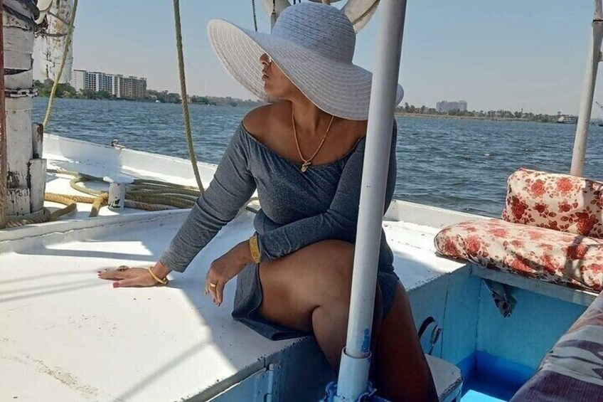 A person on a boat with a city skyline in the background. 1