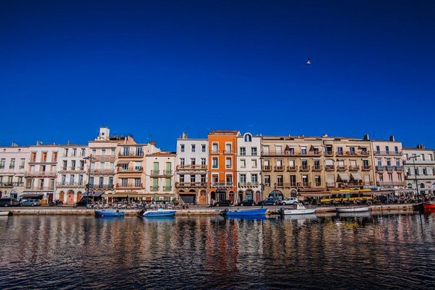 A waterfront with colorful buildings and boats. 4