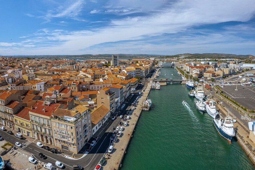 A coastal city with a river, historic buildings, and a bridge. 5