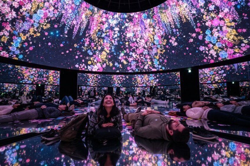 A room with a reflective floor and a ceiling filled with colorful lights. 1