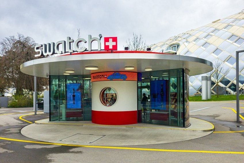 A Swatch store with a distinctive red and white color scheme, a glass facade, and a modern architectural design. 4