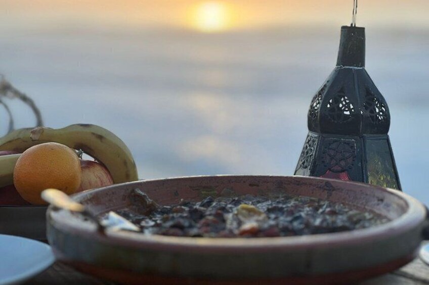 A bowl of food, a banana, an orange, and a lantern. 3