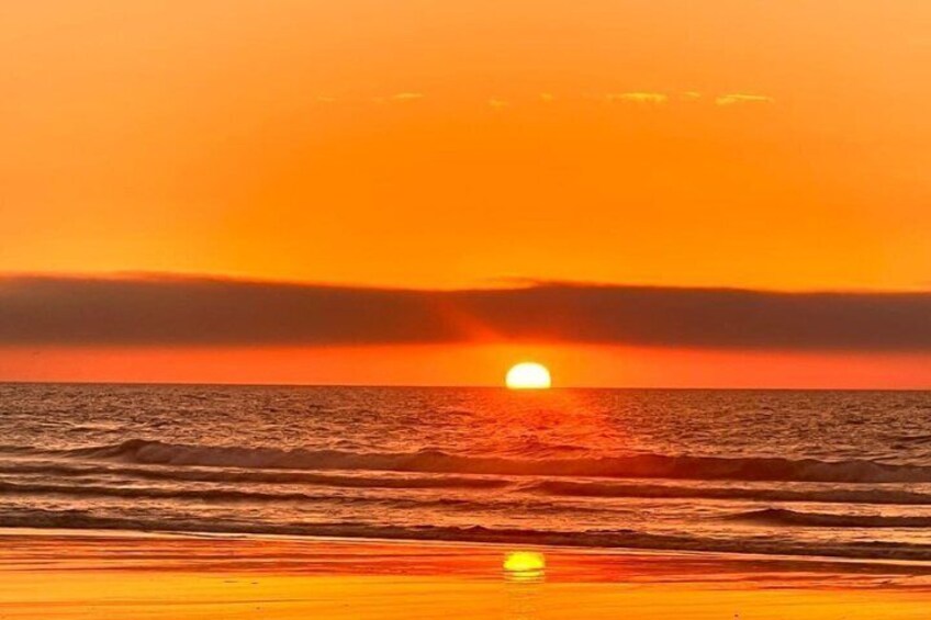 A sunset over the ocean with a visible sun reflection on the water. 4
