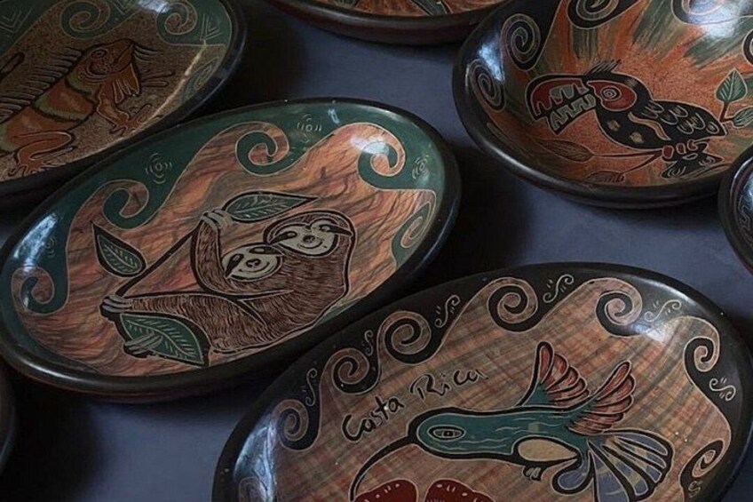 A collection of wooden boxes with intricate carvings of animals and text. 3